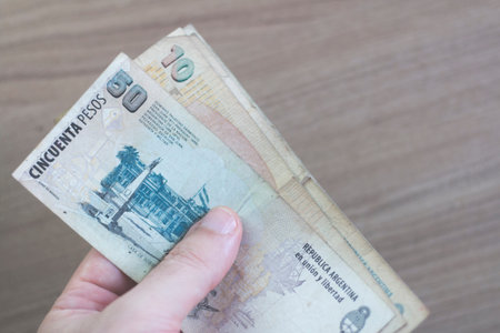 Hand holding Argentinian Money Banknotes. Argentine Money.