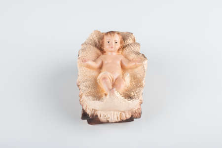 Nativity scene figurine of baby jesus with white background.の写真素材