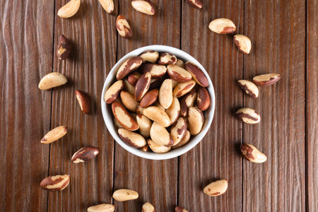 Brazil nuts on wooden background.