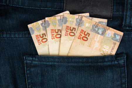Finance concept. Brazilian fifty reais banknotes in the pocket of jeans.