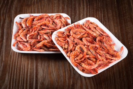 Dried shrimp on wooden background.