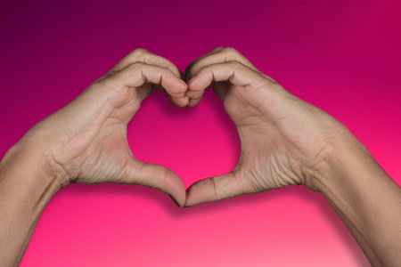Valentine's day background with hand making heart shape.