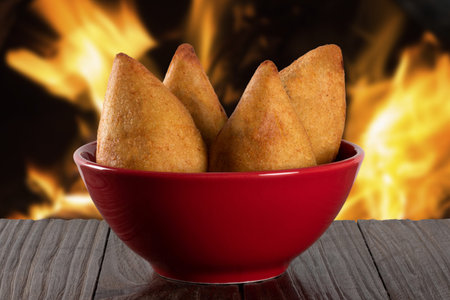 Drumstick. Traditional Brazilian snack. Background with defocused fire. chicken drumstick