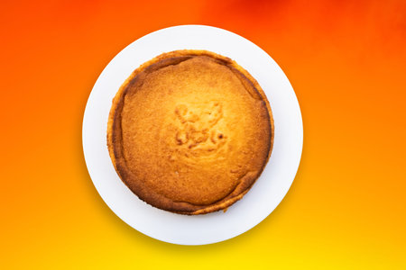 Top view cassava cake with gradient orange background.