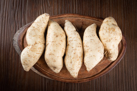 Fresh sweet potato on wooden background.の写真素材