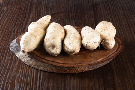 Fresh sweet potato on wooden background.の写真素材