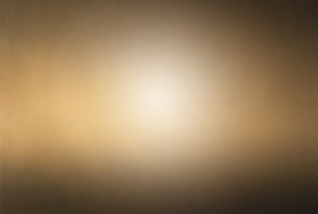 Darkened yellowish abstract texture background with light spot.の写真素材