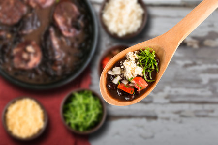 Selective focus on spoon with Brazilian Feijoada Food. Traditional Brazilian food made with black beans..の写真素材