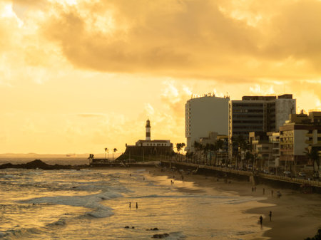 Sunset at Barra beach in Salvador Bahia with Barra Lighthouse in the background.