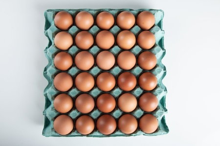 Brown egg carton with white background.