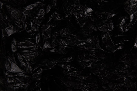 black crumpled paper texture.の写真素材