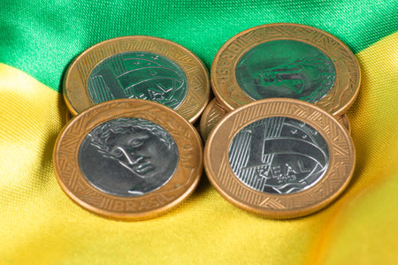 Brazilian one real coins arranged on Brazilian flag.の写真素材