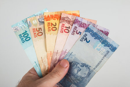 Brazilian Money. Brazilian Real notes in hand.の写真素材