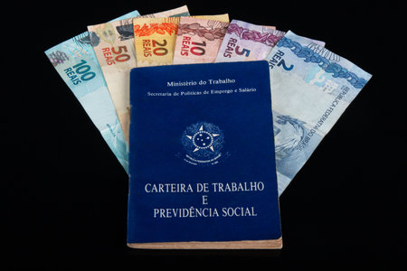 Brazilian work and social security document with real currency banknotes.の写真素材