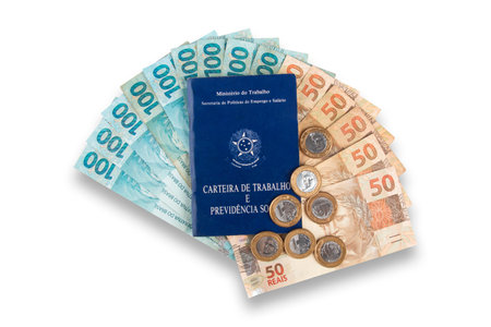 Brazilian work card with money and coins. Economy and salary concept.の写真素材