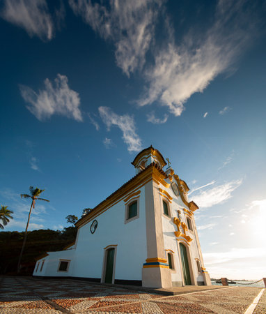 Baroque church Our Lady of Loreto on Frades Island Brazil under dramatic blue sky.の写真素材