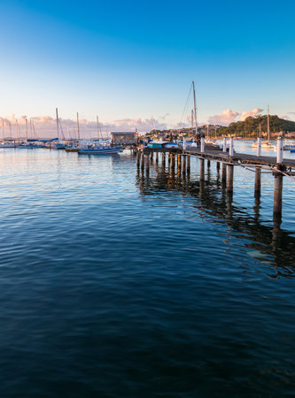 Tranquil marina at sunset with wooden pier sailboats in Ribeira in Salvador Bahia.の写真素材