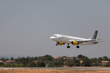 Manises, Spain - June 16, 2016: Vueling Airbus A320 landing at Manises airport in Valencia, Spainのeditorial素材