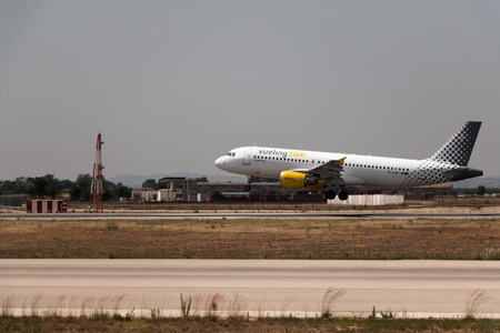Manises, Spain - June 16, 2016: Vueling Airbus A320 landing at Manises airport in Valencia, Spainのeditorial素材