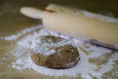 Balls of integral dough with rolling pin on wooden boardの写真素材