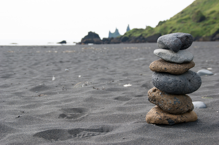 Stack of pebble stones at the black sand beach in the south of Iceland.の写真素材