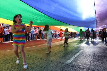 Valencia, Spain - June 18, 2016: children playing under the rainbow flag on gay pride dayのeditorial素材