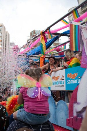 Valencia, Spain - June 16, 2018: A girl with butterfly wings on her back watching the gay pride day floatsのeditorial素材