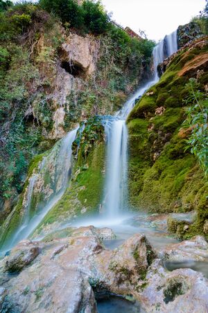 Famous waterfalls with silk effect with a crystalline water running between the houses and flowing  to the Ebro river in Orbaneja del Castillo (Burgos, Spain).  Nature concept.の写真素材