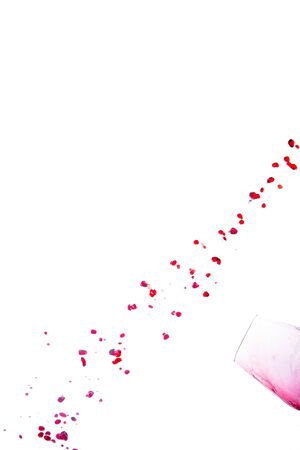 Spilled red wine drops forming a diagonal line on a white background. Abstract conceptの写真素材
