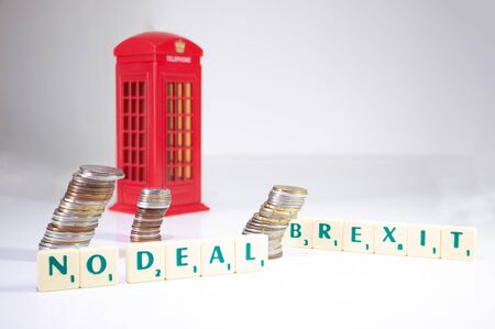 UK No Deal Brexit. The words spelled out on a white background with coins and an English telephone booth. Brexit conceptの写真素材