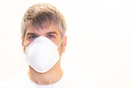 Portrait of a gray-haired man with a mask on white background. Pandemic conceptの写真素材