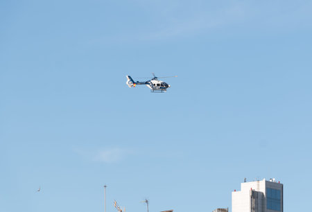 Helicopter of the Spanish national police, model Eurocopter EC 135P2 +, in surveillance tasks during the confinement by Covid-19のeditorial素材