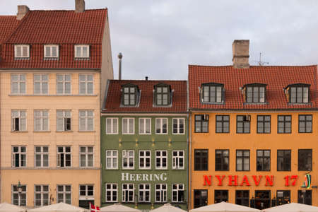Copenhagen, Denmark - August 23, 2019: Front view of colored buildings of Nyhavn in summertime in Copenhagen, Denmarkのeditorial素材