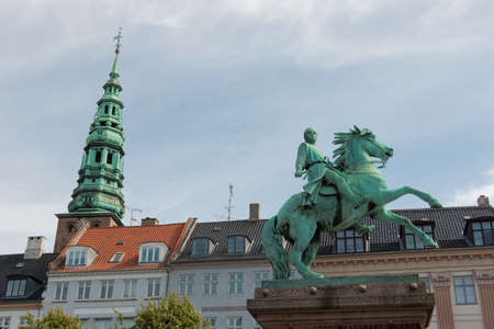 Copenhagen, Denmark - August 22, 2019: Equestrian statue of Bishop Absalon on HÃ¸jbro Plads and Nikolaj Kunsthall bell tower in the background in Copenhagenのeditorial素材
