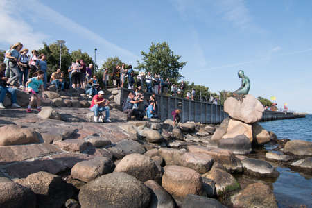 Copenhagen, Denmark - August 22, 2019: The little mermaid sculpture full of tourists around trying to take a photo at the Langelinie promenade in Copenhagen, Denmarkのeditorial素材