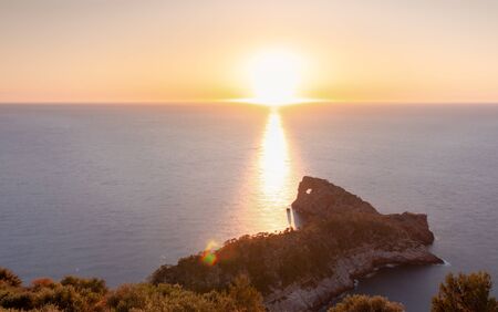 Sun setting by the horizon line of the sea in "Sa Foradada", a peninsula of the Sierra de Tramuntana in Mallorca. Nature conceptの写真素材