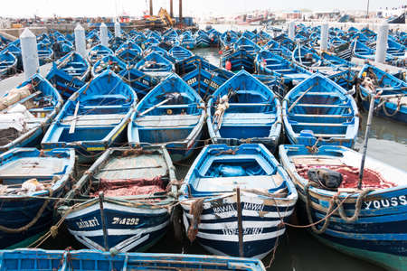 Essaouira, Morocco - March 16, 2018: A multitude of blue fishing boats typical of the city are docked in the port of Essaouiraのeditorial素材