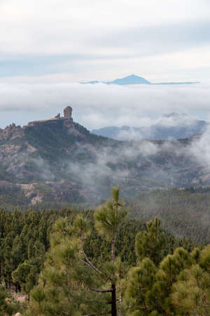 Scenic view of Roque Nublo and El Teide with sea of clouds bellow them and pine forest in foreground in Gran Canaria, Spain. Natur conceptの写真素材