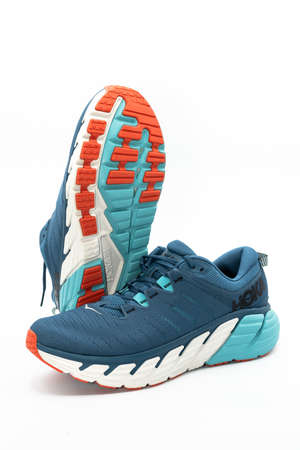 Valencia, Spain -November 7, 2021: Studio shot of a pair of Hoka One One Gaviota 3 running shoes showing the sole of one of them on white backgroundのeditorial素材
