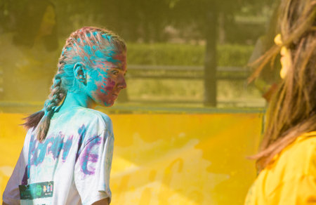 Valencia, Spain - April 27, 2019: Girl covered with multi colored powders portrait participating the "Holi life" raceのeditorial素材