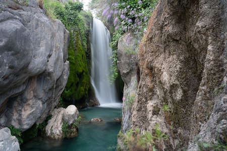 A waterfall with a silky effect at the bottom of a canyon. Nature in Alicante, Spainの写真素材