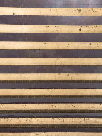 Vertical background of Solar panels in row in a solar energy generation farm also called solar park....