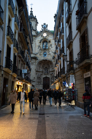San Sebastian, Spain - April 17, 2022: The main street of San Sebastian with the Basilica of Our Lady of the Choir in the background and people walkingのeditorial素材