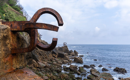 San Sebastian, Spain - April 18, 2022: Sculpture "Comb of the Wind" located in Ondarreta Beach, San Sebastian, Spain. Created by the Basque sculptor Eduardo Chillida in 1977のeditorial素材