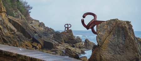 San Sebastian, Spain - April 18, 2022: Sculpture "Comb of the Wind" located in Ondarreta Beach, San Sebastian, Spain. Created by the Basque sculptor Eduardo Chillida in 1977のeditorial素材