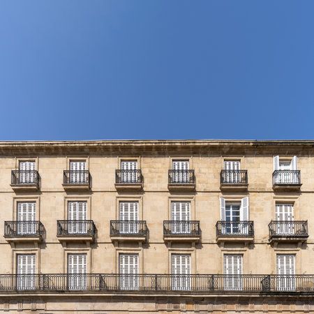 Front view of an old building facade full of balconies with blue sky and copy space. Architecture background conceptの写真素材