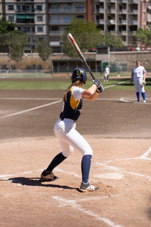 Valencia, Spain - May 14, 2023: A female batter alone ready to hit the ball in a baseball match in the Turia river in Valenciaのeditorial素材