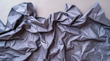 Flat lay of blue-gray sheet of paper very wrinkled and full of folds on a white surface. Disorder conceptの素材
