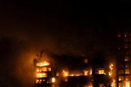 A large fire in a residential building in the city of Valencia, Spain, which quickly burns to the ground. View of the facade with a large column of smoke.のeditorial素材