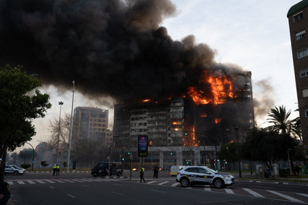 Valencia, Spain - February 22, 2024: Emergency services attend to a large fire in a residential building in the city of Valencia, which quickly burns to the ground with the area cordoned offのeditorial素材